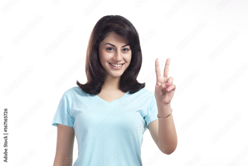 Portrait of a woman giving peace sign Portrait of a woman giving peace sign