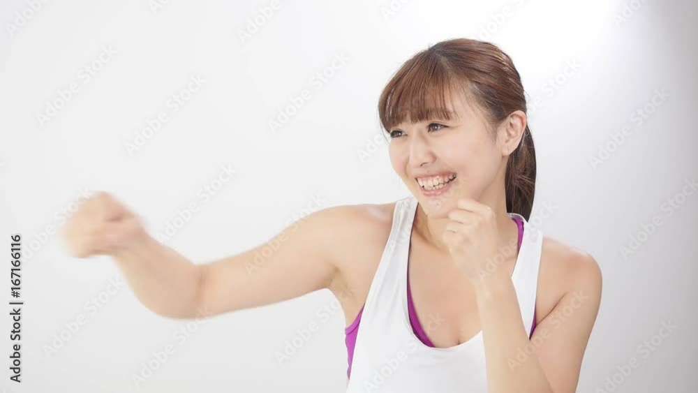 sporty asian woman boxercising in slow motion isolated on white background sporty asian woman boxercising in slow motion isolated on white background