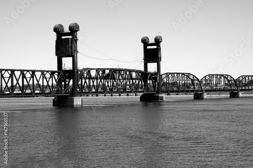 black and white photo of railraod bridge over water photo