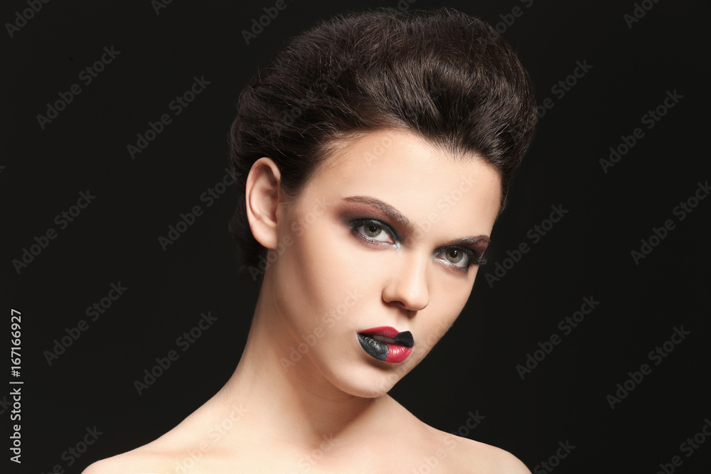 Beautiful young woman with creative makeup on dark background Beautiful young woman with creative makeup on dark background