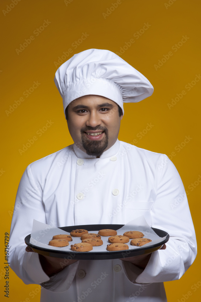 Portrait of chef with tray of cookies Portrait of chef with tray of cookies