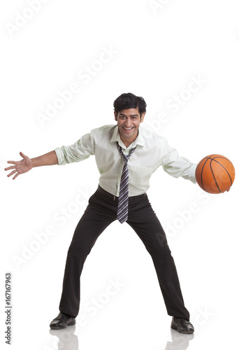 Businessman playing basketball 