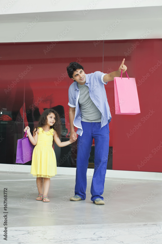 Full length of father and daughter pointing at something Full length of father and daughter pointing at something