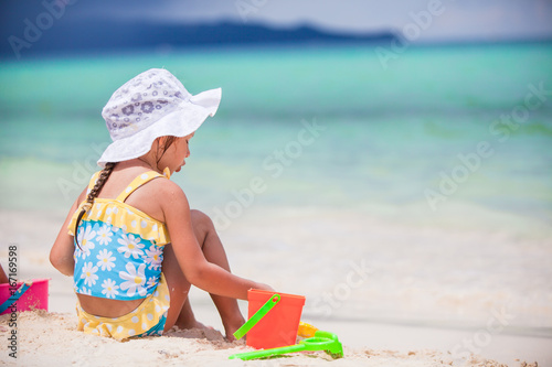 Back view of little girl play on the beach © travnikovstudio