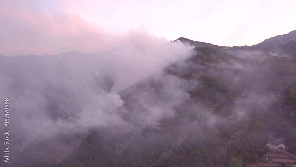 aerial view video 4K, summer fires in Europe forests 2017, 9th of august Montenegro Lovcen, aircraft extinguishes a fire, white smoke clouds, the trees are burning, aero video shooting aerial view video 4K, summer fires in Europe forests 2017, 9th of august Montenegro Lovcen, aircraft extinguishes a fire, white smoke clouds, the trees are burning, aero video shooting