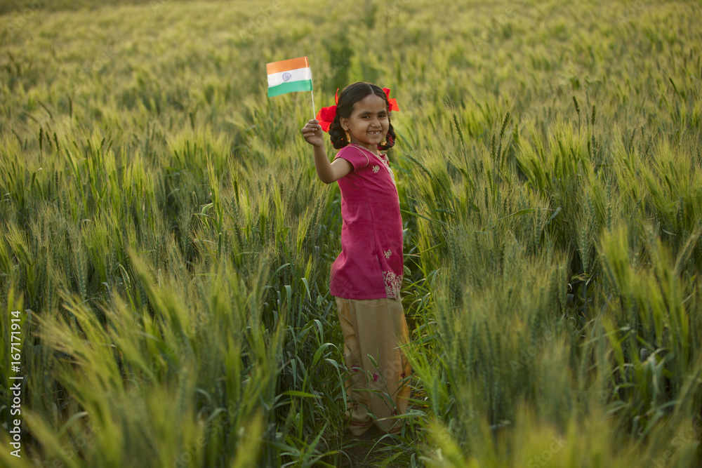 Portrait of a happy little girl holding an Indian flag Portrait of a happy little girl holding an Indian flag