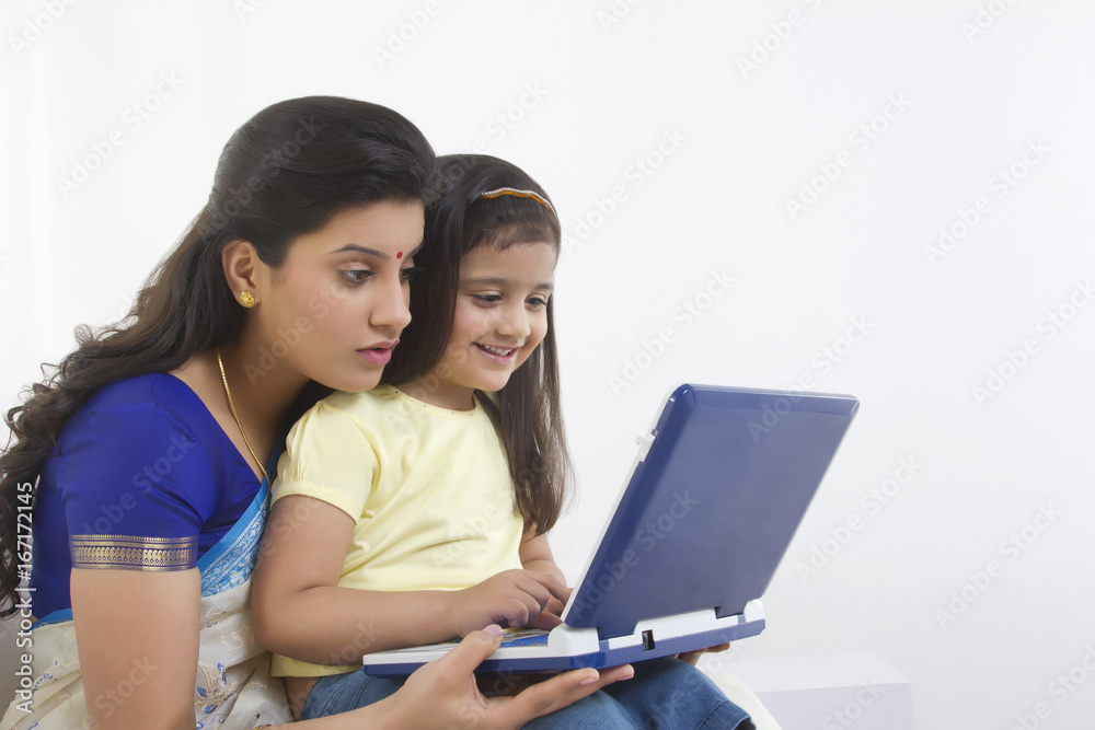 Mother and daughter with a computer
