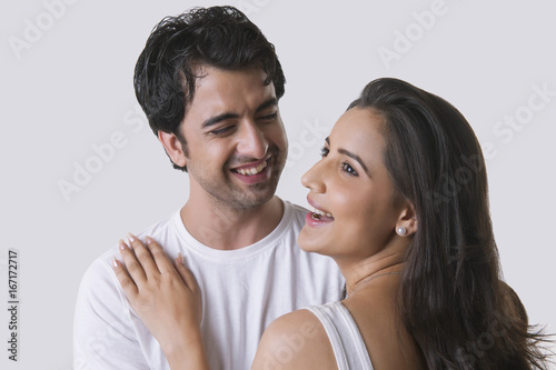 Happy young couple against white background