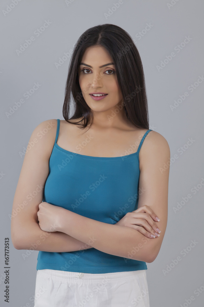 Portrait of a confident woman standing against gray background Portrait of a confident woman standing against gray background
