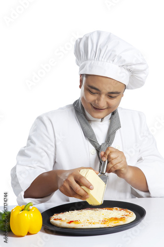 Chef grating cheese on pizza photo