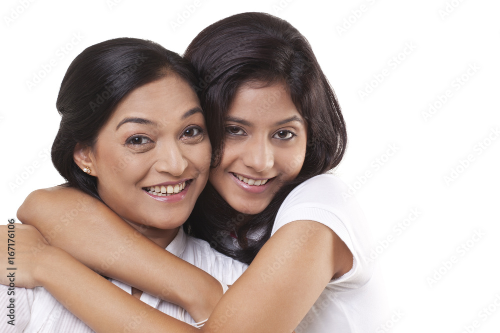 Portrait of happy mother and daughter embracing Portrait of happy mother and daughter embracing