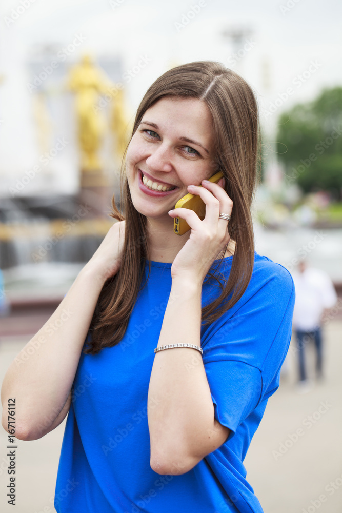 Beautiful young brunette woman calling by phone Beautiful young brunette woman calling by phone