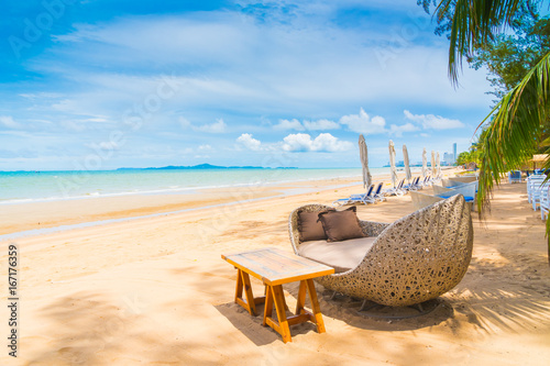 Sticker Chair and table dinning on the beach and sea with blue sky