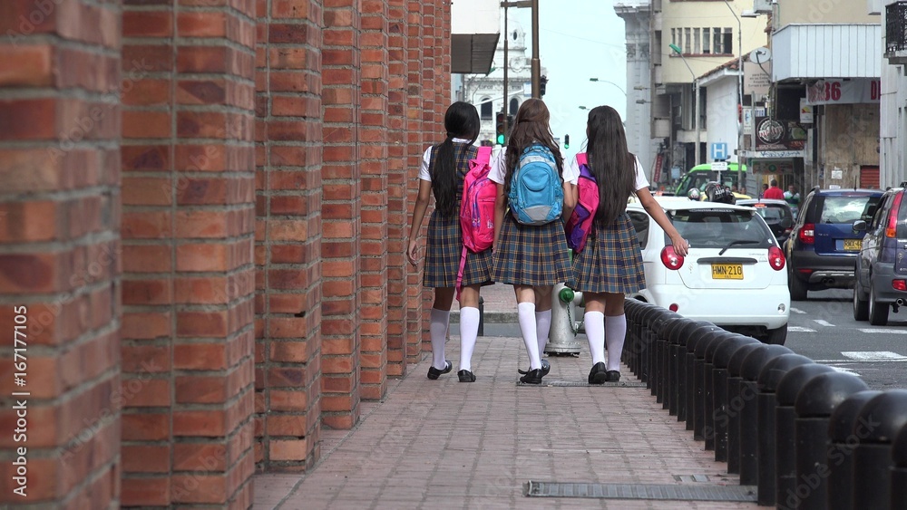 Female Teen Students Walking With Backpacks