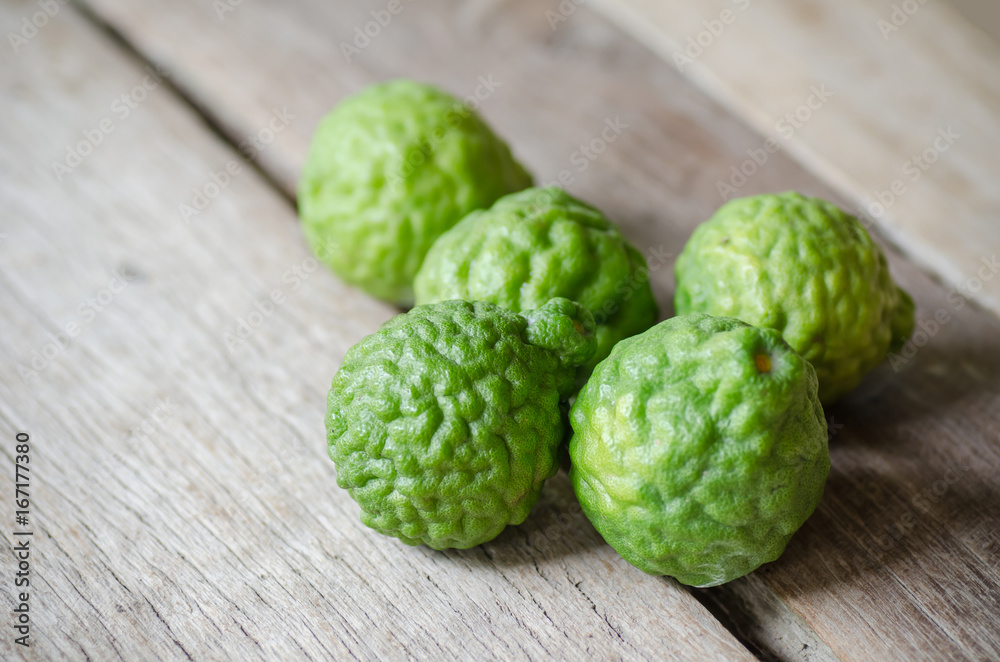 Fototapeta premium Bergamot fruit or Kaffir lime on wooden background.Thai herbal plant