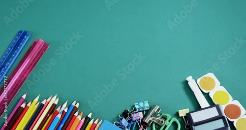 School supplies arranged on green background photo