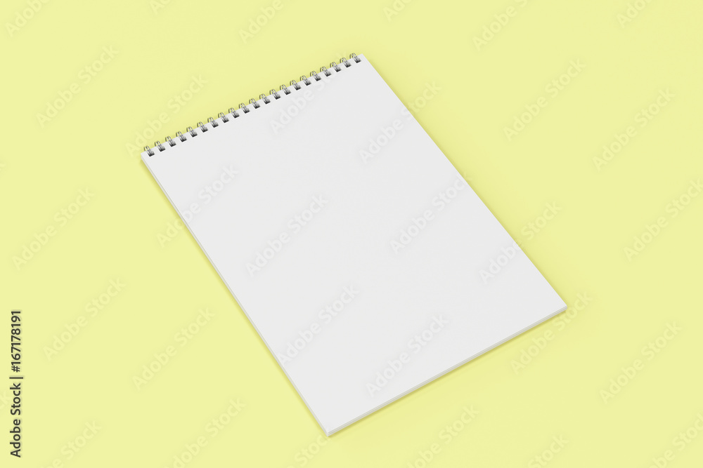 Blank white notebook with metal spiral bound on yellow background Blank white notebook with metal spiral bound on yellow background