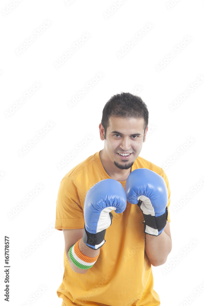 Portrait of an Indian male boxing player isolated over white background 