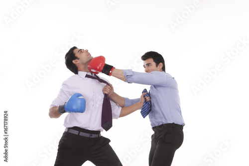 Two male executives boxing