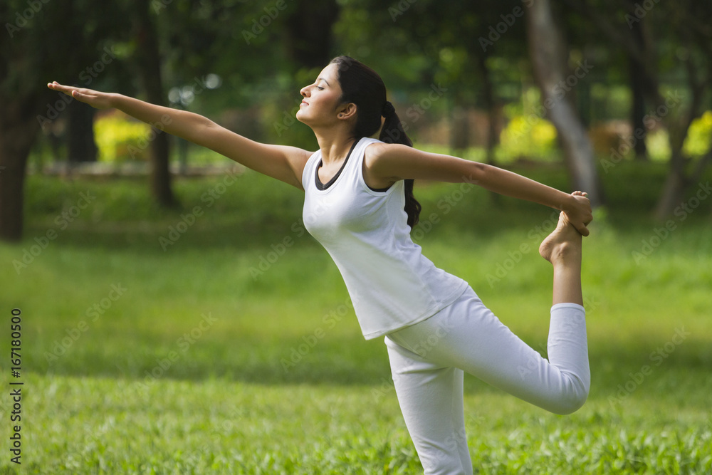 Young woman practicing yoga in a park Young woman practicing yoga in a park