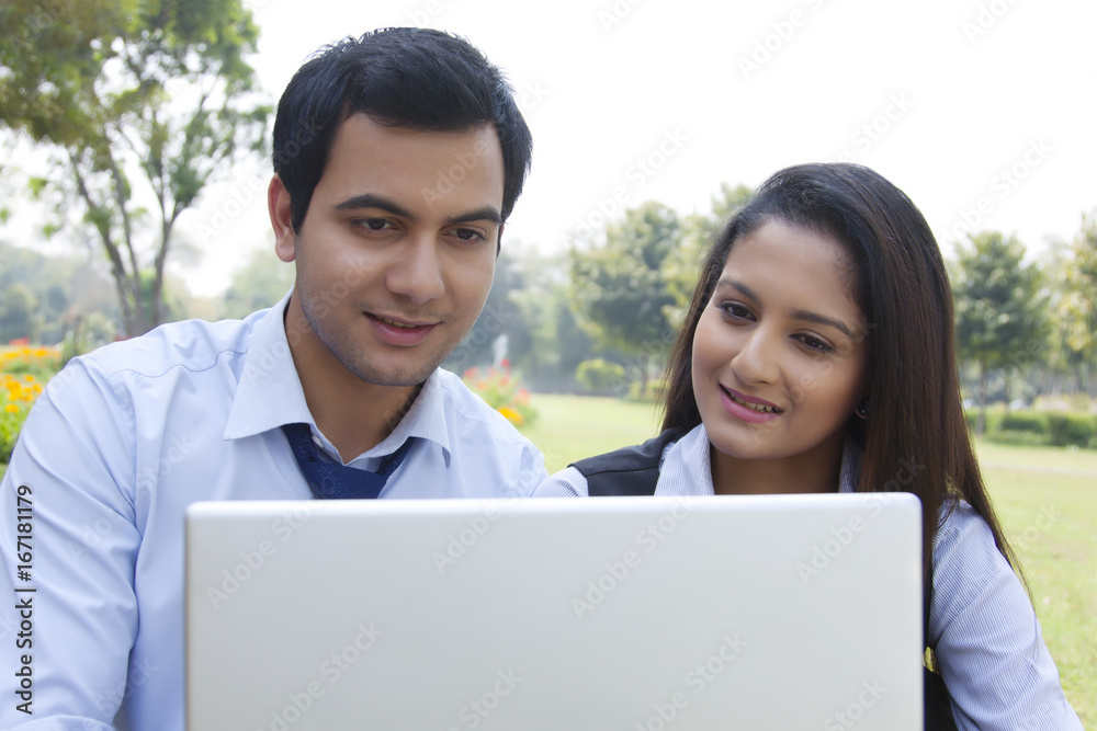 Businessman and businesswoman working in a park Businessman and businesswoman working in a park