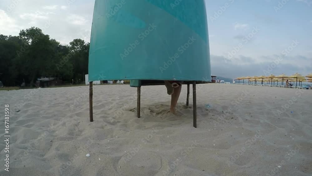Woman Putting Off Bikini in Changing Cabin on the Beach ...