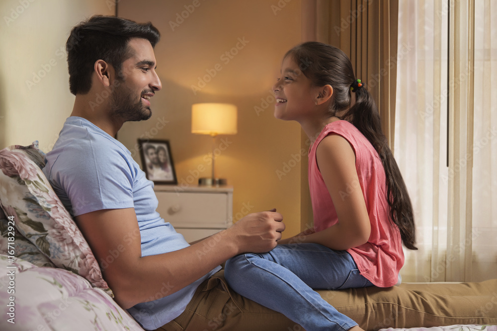 Father and daughter playing on bed Father and daughter playing on bed