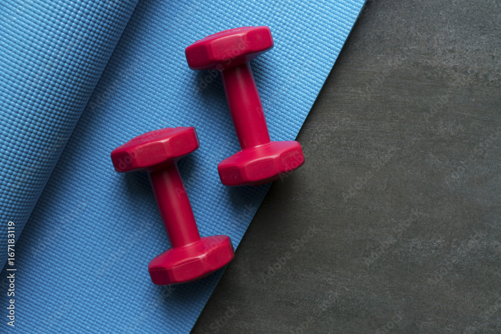 Fototapeta premium dumbbell and yoga mat on table, fitness healthy and sport concept
