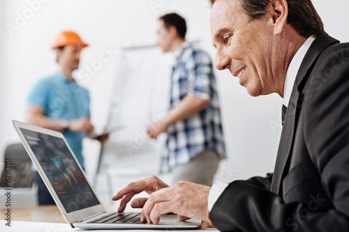 Senior man in a suit working on his laptop