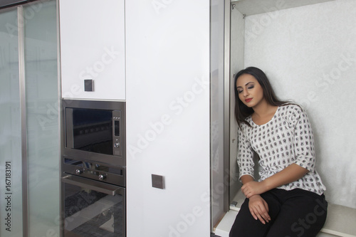 Young woman sleeping in the kitchen