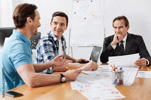 Bristled man giving a report to his colleagues