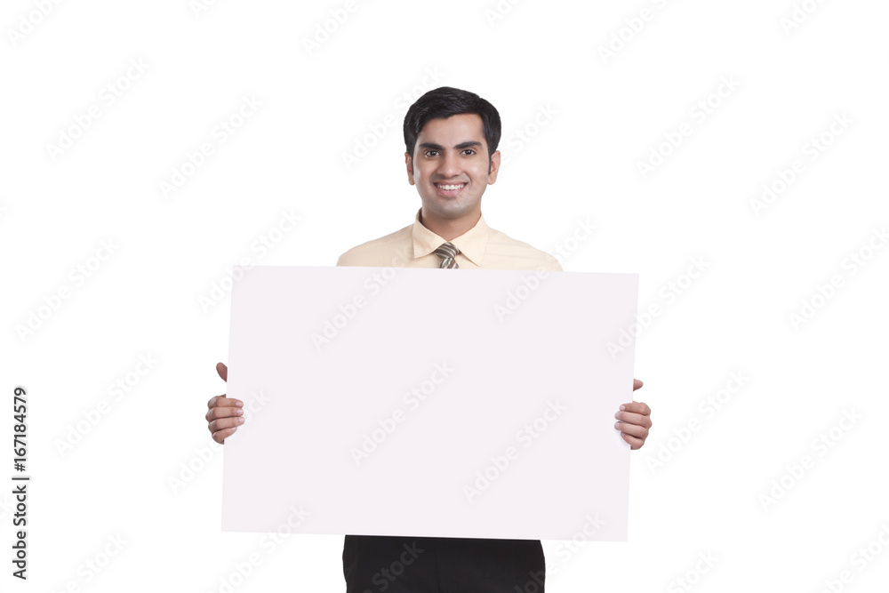 Portrait of smiling businessman showing empty placard over white background Portrait of smiling businessman showing empty placard over white background