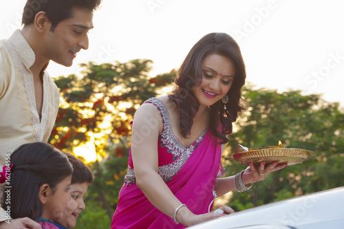 Woman putting tili on new car photo