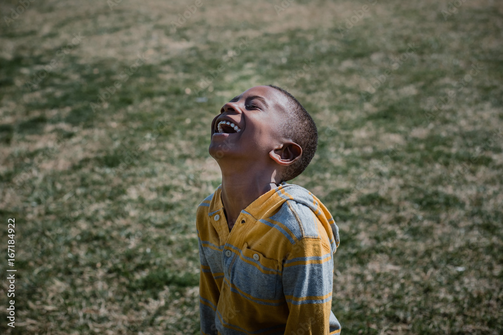 boy with joyful expression laughing outside boy with joyful expression laughing outside