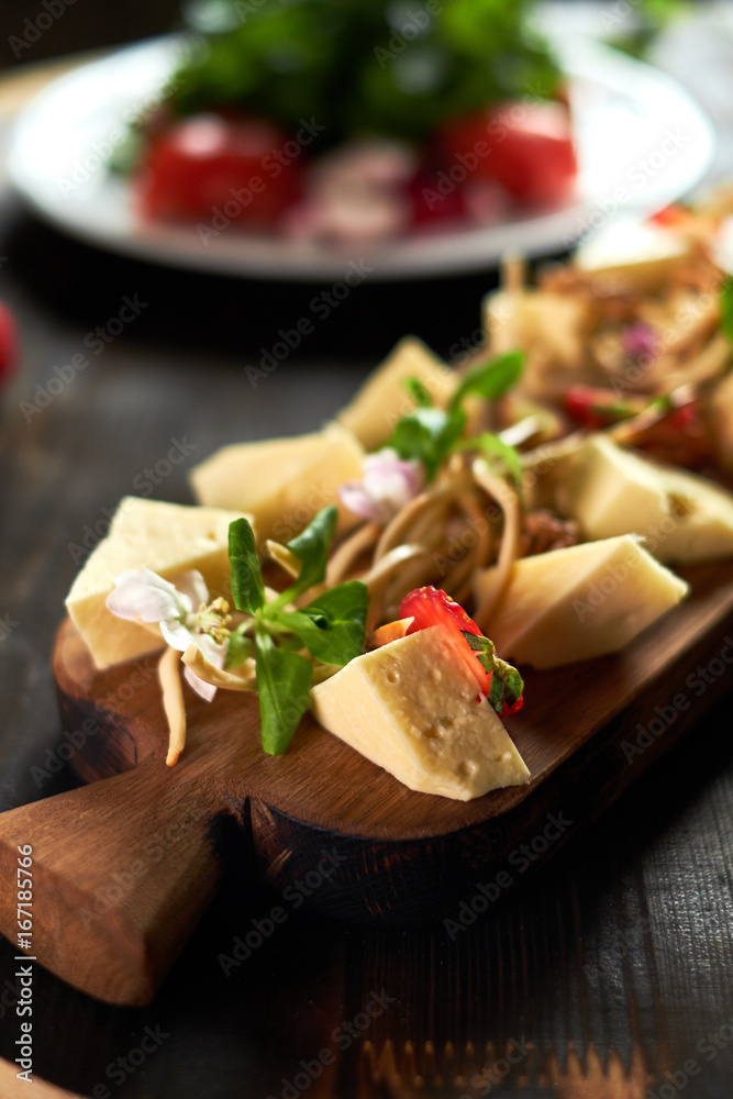 Pieces of cheese on a board with vegetables hd Pieces of cheese on a board with vegetables hd