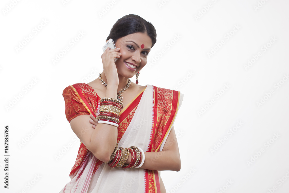 Portrait of a Bengali woman talking on a mobile phone Portrait of a Bengali woman talking on a mobile phone