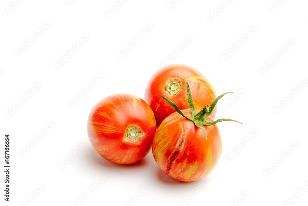 Three juicy red zebra tomatoes, isolated on white background Three juicy red zebra tomatoes, isolated on white background