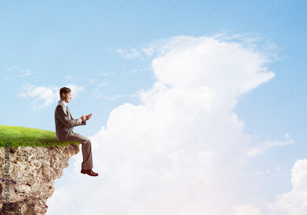 Businessman in suit with smartphone in hands send message