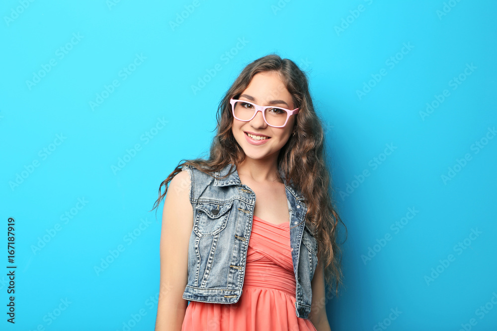 Portrait of young woman with glasses on blue background Portrait of young woman with glasses on blue background