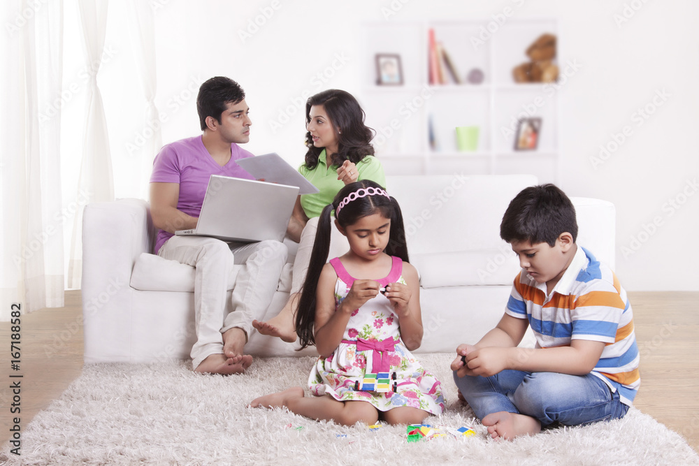 Parents discussing while children play