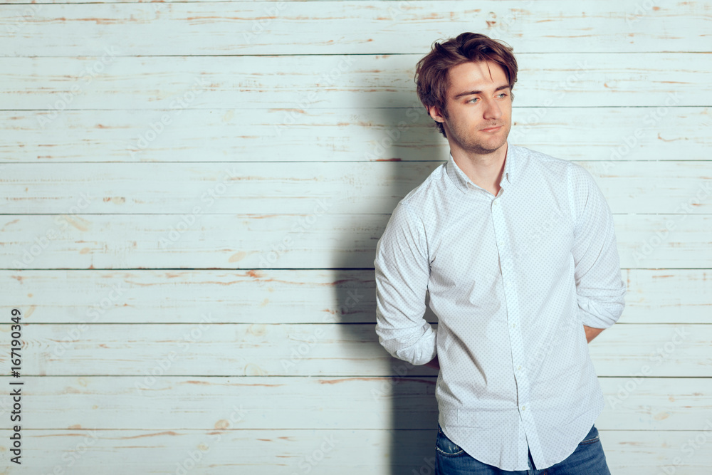 Portrait of a handsome man on old wooden background Portrait of a handsome man on old wooden background