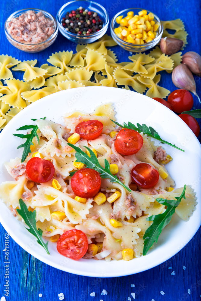 Pasta salad with tomatoes cherry, tuna, corn and arugula. Top view. Pasta salad with tomatoes cherry, tuna, corn and arugula. Top view.