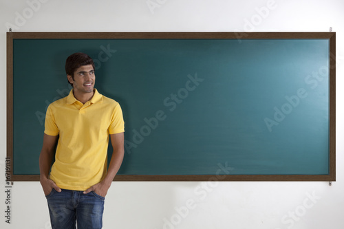 College student standing in front of blackboard © IndiaPix