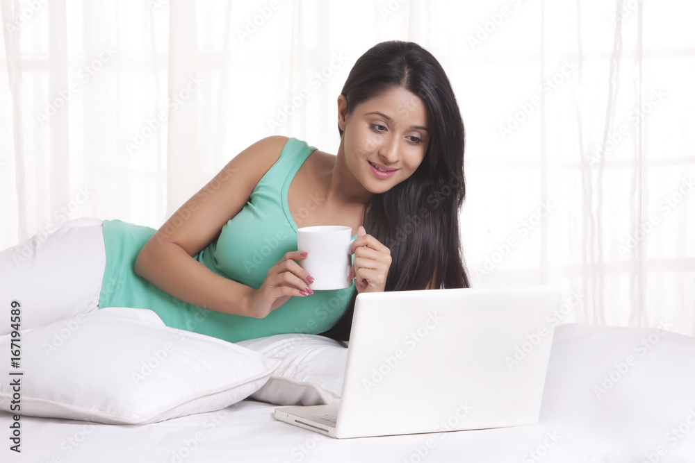 Young WOMEN using laptop while having coffee Young WOMEN using laptop while having coffee