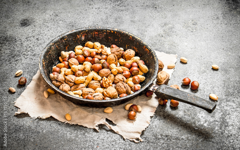 Fototapeta premium Different nuts in a frying pan.