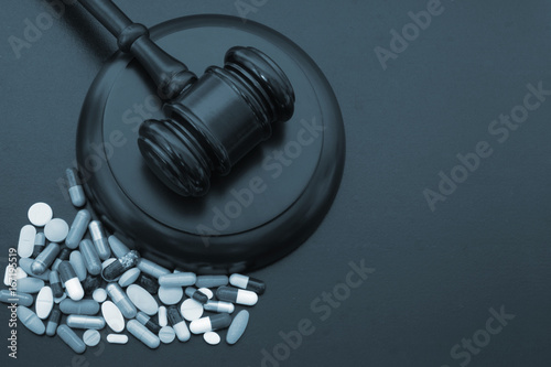 фотографія Wooden judge gavel with drugs on table with copyspace