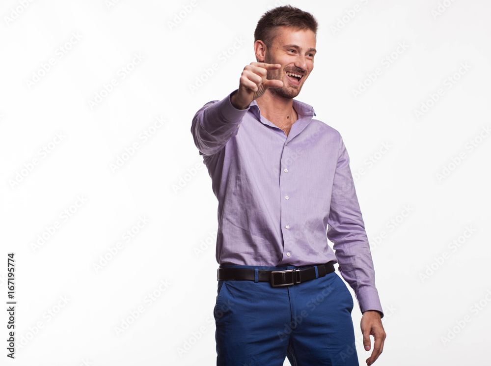 Young cheerful man portrait of a confident businessman showing by hands on a gray background. Ideal for banners, registration forms, presentation, landings, presenting concept. Young cheerful man portrait of a confident businessman showing by hands on a gray background. Ideal for banners, registration forms, presentation, landings, presenting concept.