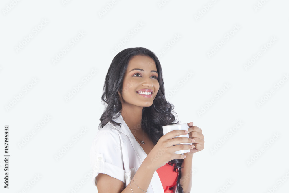 Woman with a mug of tea smiling Woman with a mug of tea smiling