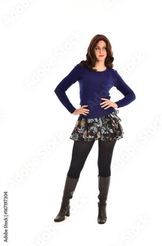 Full length portrait of a brunette girl wearing casual modern clothes. standing pose, isolated against white background
