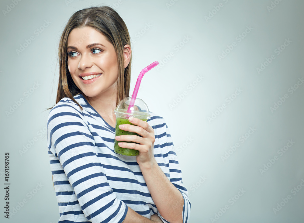 Smiling woman looking side holding green cocktail Smiling woman looking side holding green cocktail